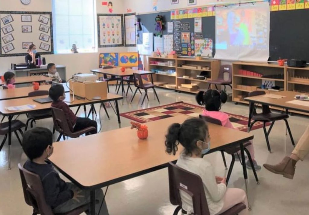 pre-school students watching a virtual presentation