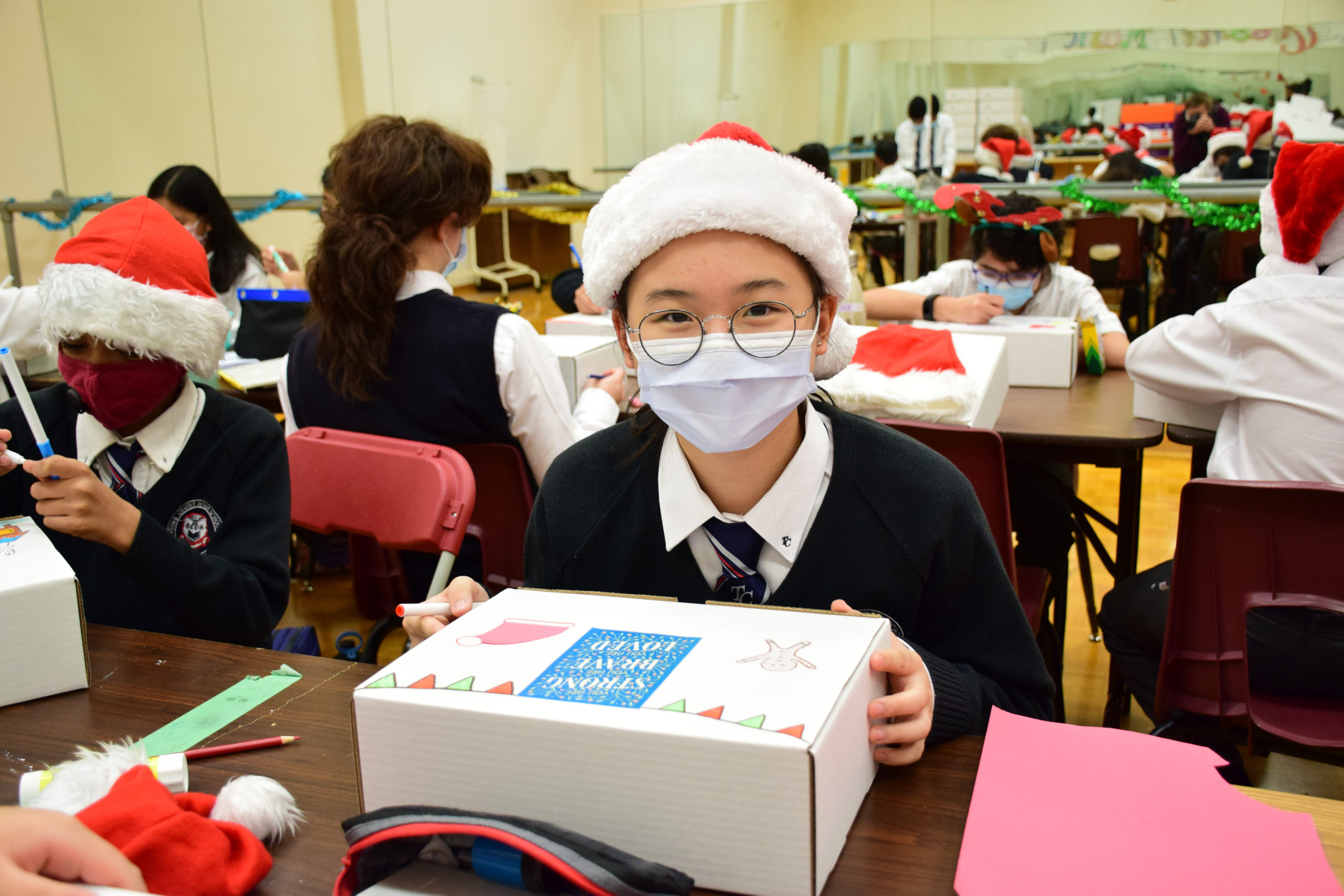Elementary student working on gift boxes